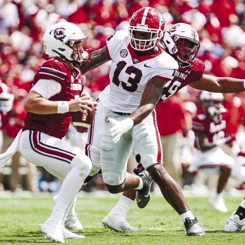 ADAM WALSH/UGA Athletics Georgia defensive lineman Mykel Williams (13) closes in on South Carolina quarterback Spencer Rattler (7) during Saturday’s game.