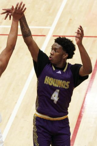 Kaden Douglas lets loose a three pointer over the reach of a Dutchtown defender. BRAD HARRISON/Staff