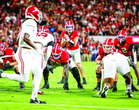Georgia quarterback Gunner Stockton (14) in the shotgun formation, getting the offense set before a play against Alabama on Sept. 27. LANCE McCURLEY/Staff