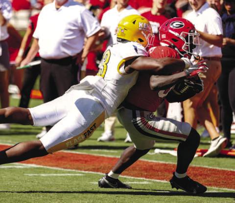 Georgia running back Daijun Edwards (30) drags a defender on his way to racking up 73 rushing yards and nine receiving yards against Kent State. KAYLA RENIE/UGA Athletics
