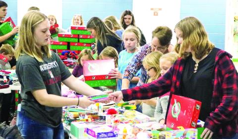 Children at Elam Baptist Church in Gray choose items to put in shoeboxes for Operation Christmas Child. NATHAN CLARKE/Contributed
