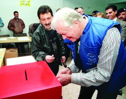 Former President Jimmy Carter votes at a ballot box. He monitored elections in more than 100 countries. CONTRIBUTED