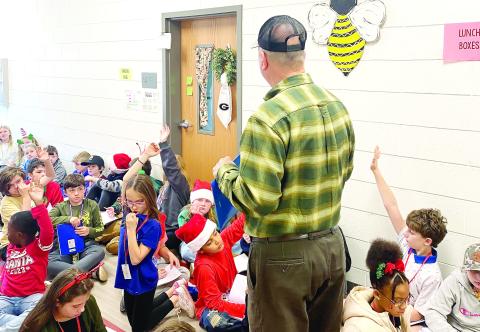 Phil Huskins, local beekeeper, shares lessons about raising bees to Dames Ferry Elementary students. BETHANY TAPPEE/Staff