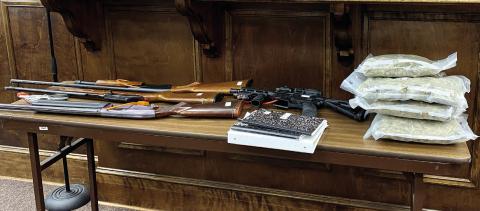 Evidence is laid out in Jones County Superior Court in anticipation of the beginning of the Sept. 25 trial for Dan Cleveland. The evidence includes vacuum-packed bags of marijuana, firearms and ledgers. DEBBIE LURIE-SMITH/Staff
