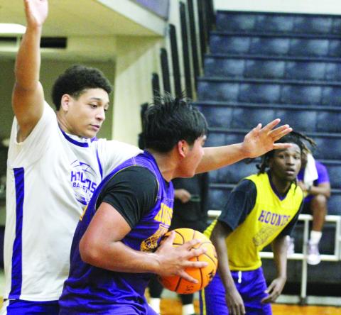 Tyler Wold, center, tries to kick the ball outside after grabbing a rebound in Saturday’s scrimmage. BRAD HARRISON/Staff