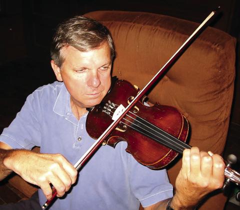 Newberry practices the violin in 2002. CONTRIBUTED