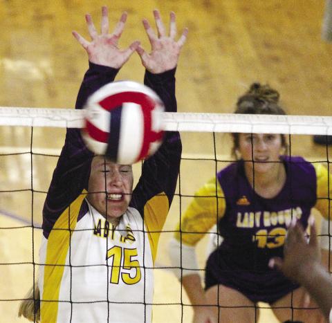 Kamryn Hardwick (15) goes up to get a block against Union Grove. BRAD HARRISON/Staff