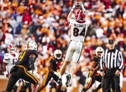 Wide receiver Ladd McConkey (84) goes up and makes a catch between multiple Tennessee defenders in last year’s game against the Volunteers. TONY WALSH/UGA Athletics