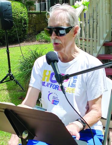 Ron Houze reads during a previous Bible reading. CONTRIBUTED