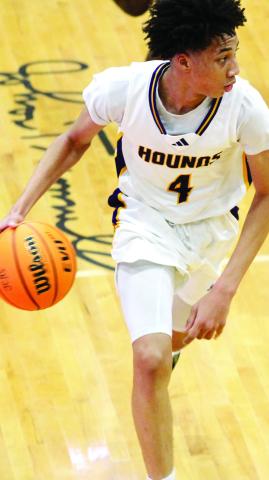 Junior guard Justin Ray takes the ball up the court in a game earlier this season. BRAD HARRISON/Staff