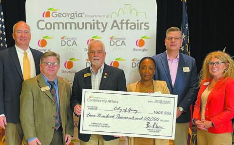Gray Mayor Ed Barbee (3rd left) accepts the $400,000 check from the Georgia Department of Community Affairs at an event held in Forsyth Nov. 8. CONTRIBUTED