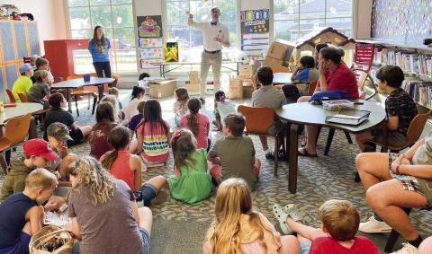 NASA Education Specialist Steven Smith speaks to children at June 18 Library Summer Reading Space Week event. DEBBIE LURIESMITH/Staff
