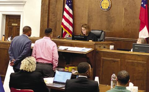 Cameren Banks (center) and his attorney Melvin Raines in front of Superior Court Judge Alison Burleson to discuss the defendant’s option of testifying at last week’s trial. DEBBIE LURIE-SMITH/Staff