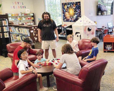Fathers and children alike enjoy Saturday’s events inside the library that included crafts, games and most importantly time together. CONTRIBUTED