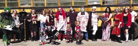 Performers at Hwy 11 Halls of Horror in front of an old school bus. CONTRIBUTED