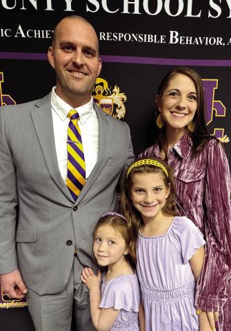 New Greyhounds head football coach Justin Montgomery and his family beam with excitement following his introduction last Tuesday. BRAD HARRISON/Staff