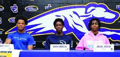 Robert Scott, Kaden Douglas and Jaleel Jordan pose after signing national letters of intent last week. CONTRIBUTED