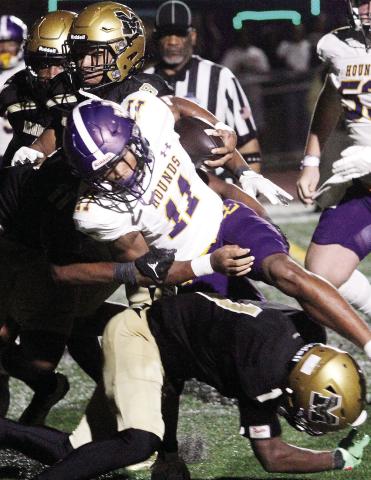 Travis Miller (11) fights for yardage during overtime against McDonough. The Greyhounds would score one play later. BRAD HARRISON/Staff