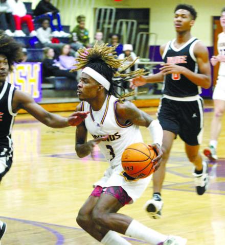 Jaylen Sanford dribbles through the lane to score two points against Stockbridge. BRAD HARRISON/Staff