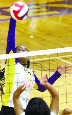 Madison Maxwell goes up to block a return against Peach County. BRAD HARRISON/Staff