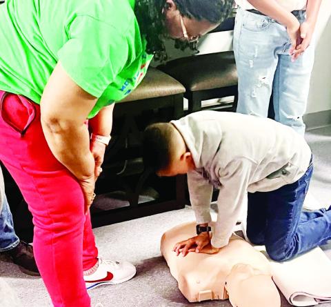 Coach at M.A.G.S teaches CPR to children
