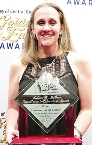 Christine Geske-Stewart holding the Sylvia W. McGee Excellence in Education Award she won. CONTRIBUTED