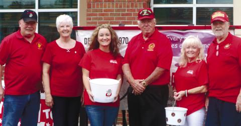 Marine Corps Detachment 970, Shana Backus and volunteers gather for a photo in front of Ingles as they raise funds for Toys for Tots for the Labor Day kicko_.  NATHAN CLARKE/ Contributed