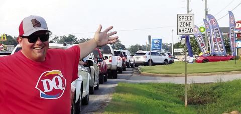 Dairy Queen owner Justin Kelly celebrates the line of traffic during last year’s Miracle Treat Day. FILE PHOTO
