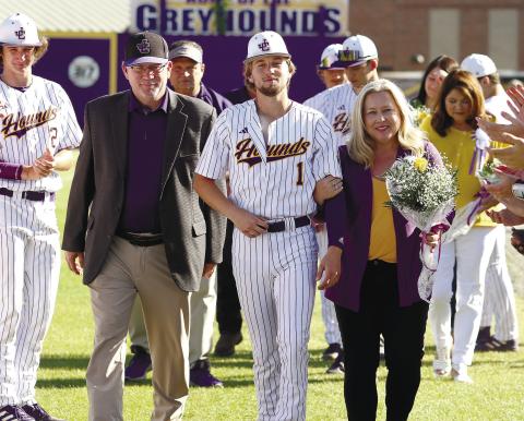 Flanked on both sides by teammates, the Greyhounds seniors were recognized before Monday’s game. Photos by BRAD HARRISON/Staff