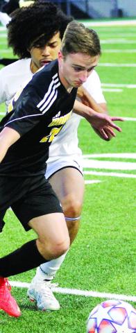 Brendan Waters keeps possession of the ball near midfield against Locust Grove. BRAD HARRISON/Staff