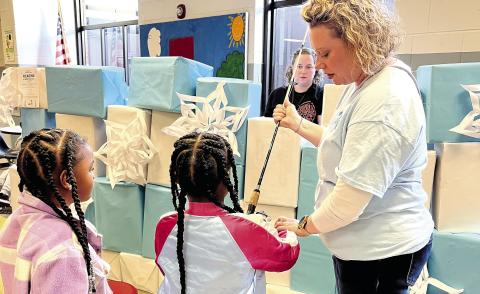 Mattie Wells Elementary students went fishing for prizes during the school’s literacy event last month. BETHANY TAPEE/Staff