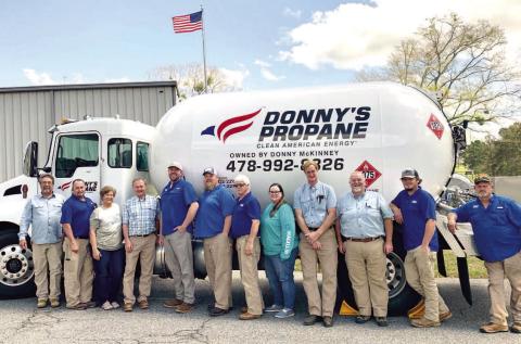 Donny’s Propane employees gather around one of the propane trucks for a photo at the company. ADAM SEGERS/Contributed