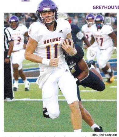Greyhounds quarterback Judd Anderson lunges out of the pocket to avoid a tackle against Dacula. BRAD HARRISON/Staff