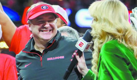 Georgia head coach Kirby Smart is all smiles during an interview with ESPN reporter Laura Rutledge after winning the SEC Championship game in Atlanta on Saturday. LANCE McCURLEY/Staff