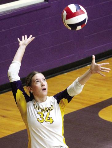 Lyndsie Hanner serves the ball up and over the net against Putnam County. BRAD HARRISON/Staff
