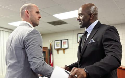 Jones County High School Head Football Coach Justin Montgomery (left) is congratulated by JCHS Principal Dennis Woolfolk after the Feb. 11 introduction. SEE MORE ON THE NEW COACH IN SPORTS >> PAGE C1 DEBBIE LURIE-SMITH/Staff