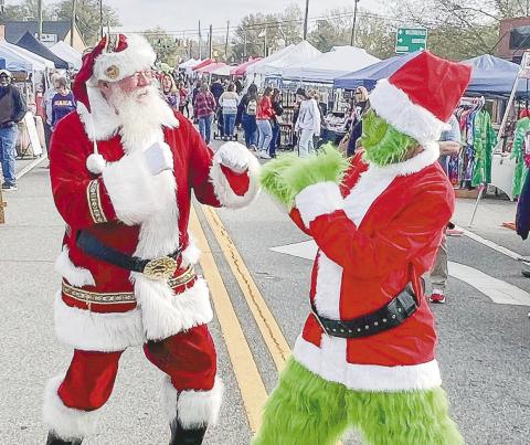 The playful meeting of Santa and the Grinch at last year’s Christmas Market. CONTRIBUTED
