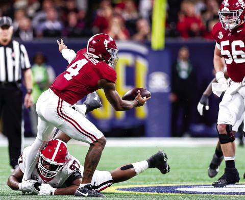 Georgia defensive lineman Warren Brinson (97) recorded a sack on Alabama quarterback Jalen Milroe (4), a tackle for loss and three tackles in the 2023 SEC Championship game in Atlanta. TONY WALSH/UGAAA
