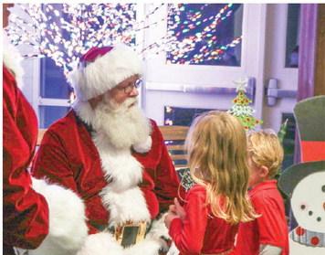 Children at Dames Ferry Elementary School greet Santa Claus and tell him what they want for Christmas. NATHAN CLARKE/Contributed