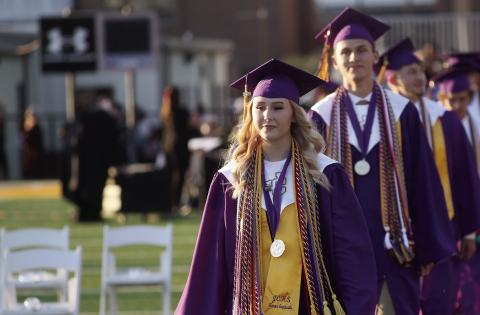 Valedictorian Ariana Epps and Salutatorian Aaron Varnadoe lead the processional at Jones County High School’s 2026 graduation ceremony that was held on the football field. The ceremony had been held in Milledgeville at Georgia College’s Centennial Center for the past several years. BRAD HARRISON/Staff
