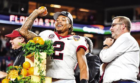 Georgia running back Kendall Milton celebrates a standout performance in the Orange Bowl, during which he carried the ball nine times for 104 yards and two touchdowns. CHARLES JORDAN/Staff