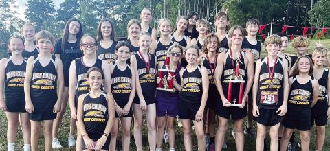 Jones County’s middle school runners pose after taking finishes of first and second overall at the Peake Invitational in Macon. CONTRIBUTED