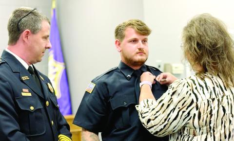 Gray Fire Department’s newest firefighter, Bryce Bullock, is pinned by his mother at the Sept. 8 Gray City Council meeting. Fire Chief Keith Eisele (left) also presented Bullock with his firefighter certificate. DEBBIE LURIE-SMITH/Staff