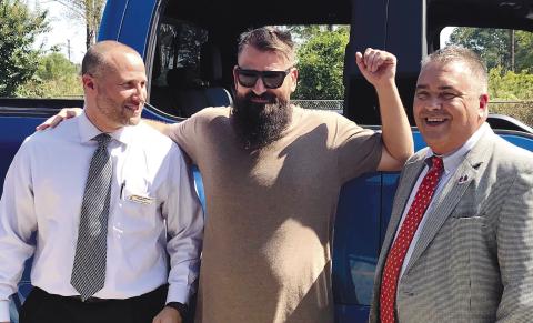 David Jones (center), JCHS Principal Lance Rackley (left) and thensuperintendent Charles Gibson in 2019, after presenting a $24,000 check to the band.  FILE PHOTO