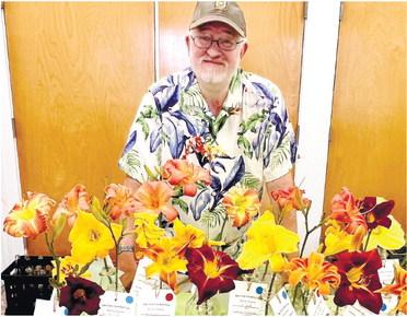 Greg Thompson, the first-place winner of the daylily contest for 2023, with his daylilies. ALAINA CLARKE/Staff