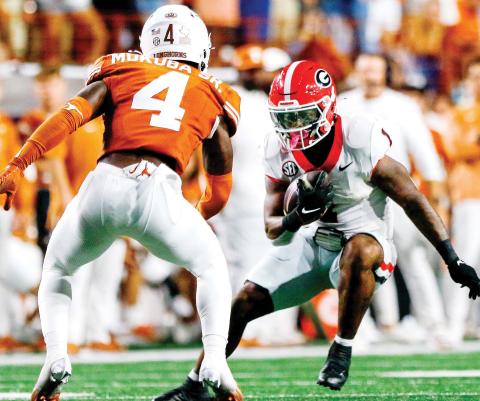 Georgia running back Trevor Etienne (1) accounted for all three Bulldog touchdowns in Austin. LANCE McCURLEY/Staff