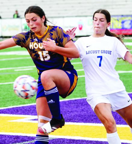 Abigail Norris chases down a loose ball on the Locust Grove end of the field on Monday. BRAD HARRISON/Staff