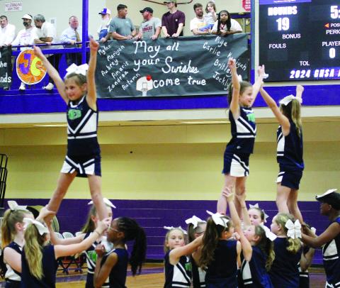 Cheerleaders from Turner Woods Elementary keep the crowd energized during last Tuesday’s GHSA girls basketball state quarterfinal game against Midtown. 