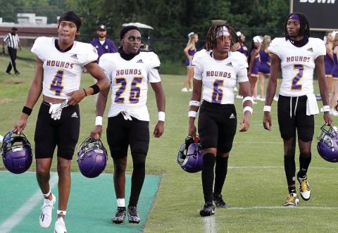 The Greyhounds captains for Friday’s scrimmage at Mary Persons, from left, Jaivon Solomon, David Little, Zach Hurt, and Devin Edmonds make their way up the sideline before kickoff. BRAD HARRISON/Staff