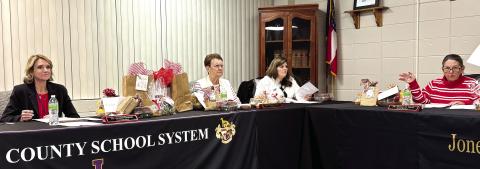 Dr. Jessica Graves (left) takes her place as superintendent of Jones County Schools at the Dec. 9 Board of Education meeting. DEBBIE LURIE-SMITH/Staff
